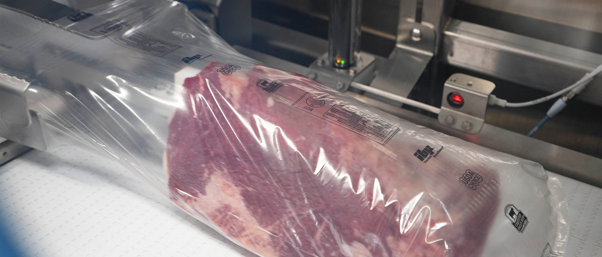 meat loaded into a bag by a robotic bag loader