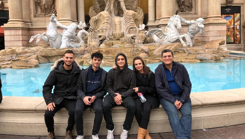 ahmed saad with his family in front of a fountain