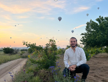 ahmed saad outside with hot air balloons in the background