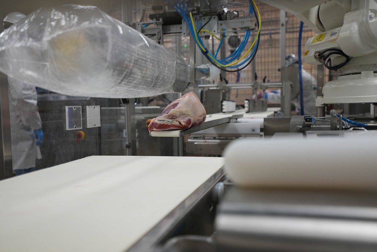 meat being loaded into a plastic bag