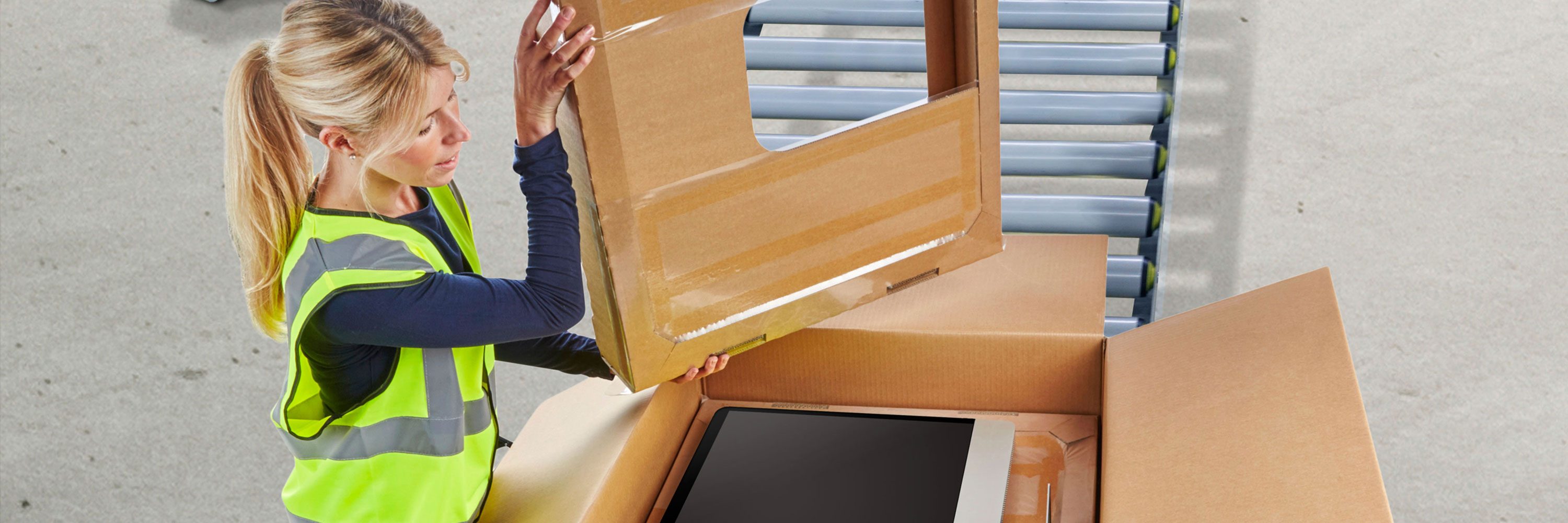 woman packing a television korrvu box