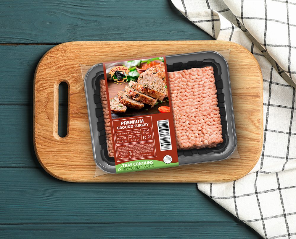Display on a wooden board: Ground turkey packaged in sustainable material.