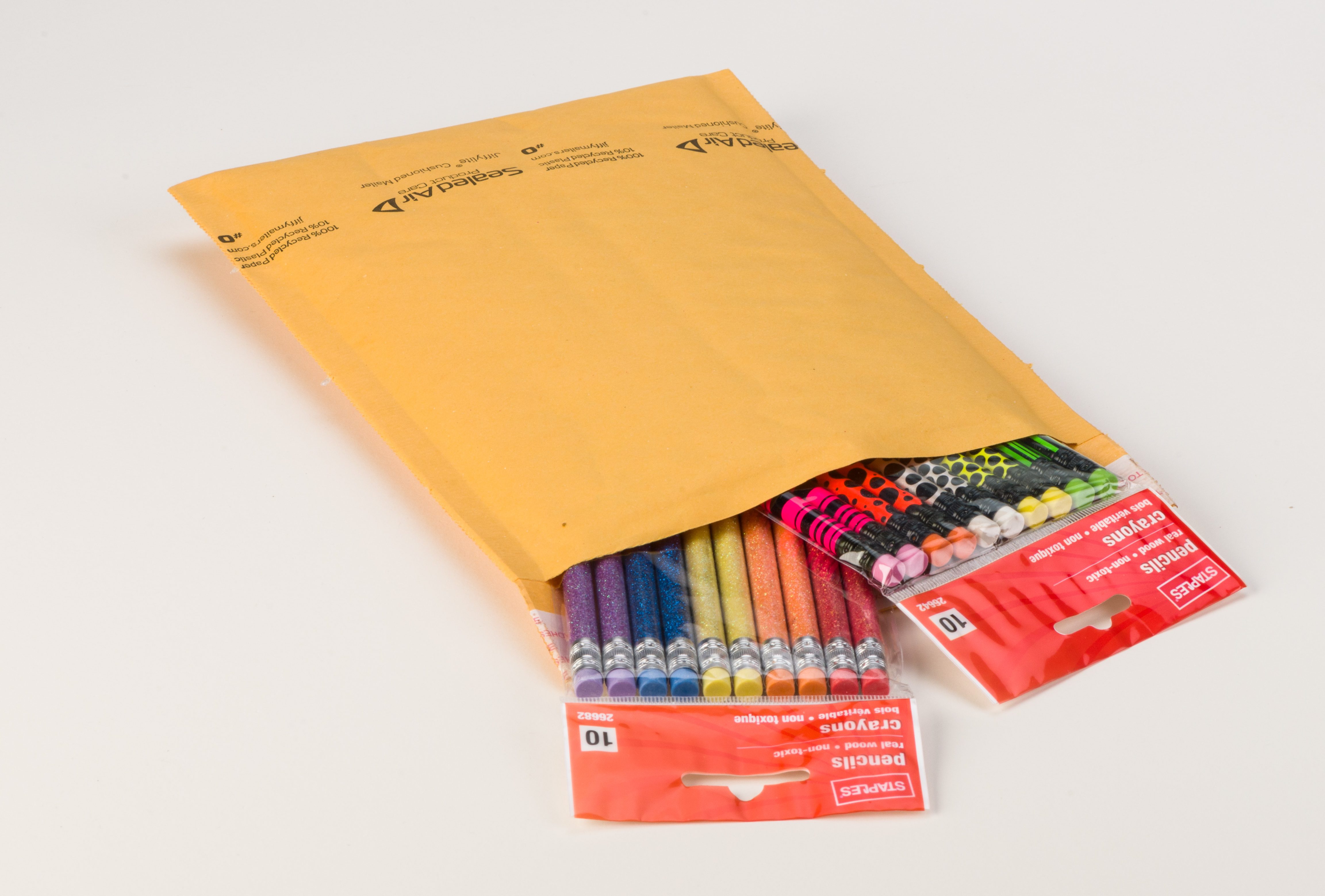 colorful pencils in a yellow cushioned mailer