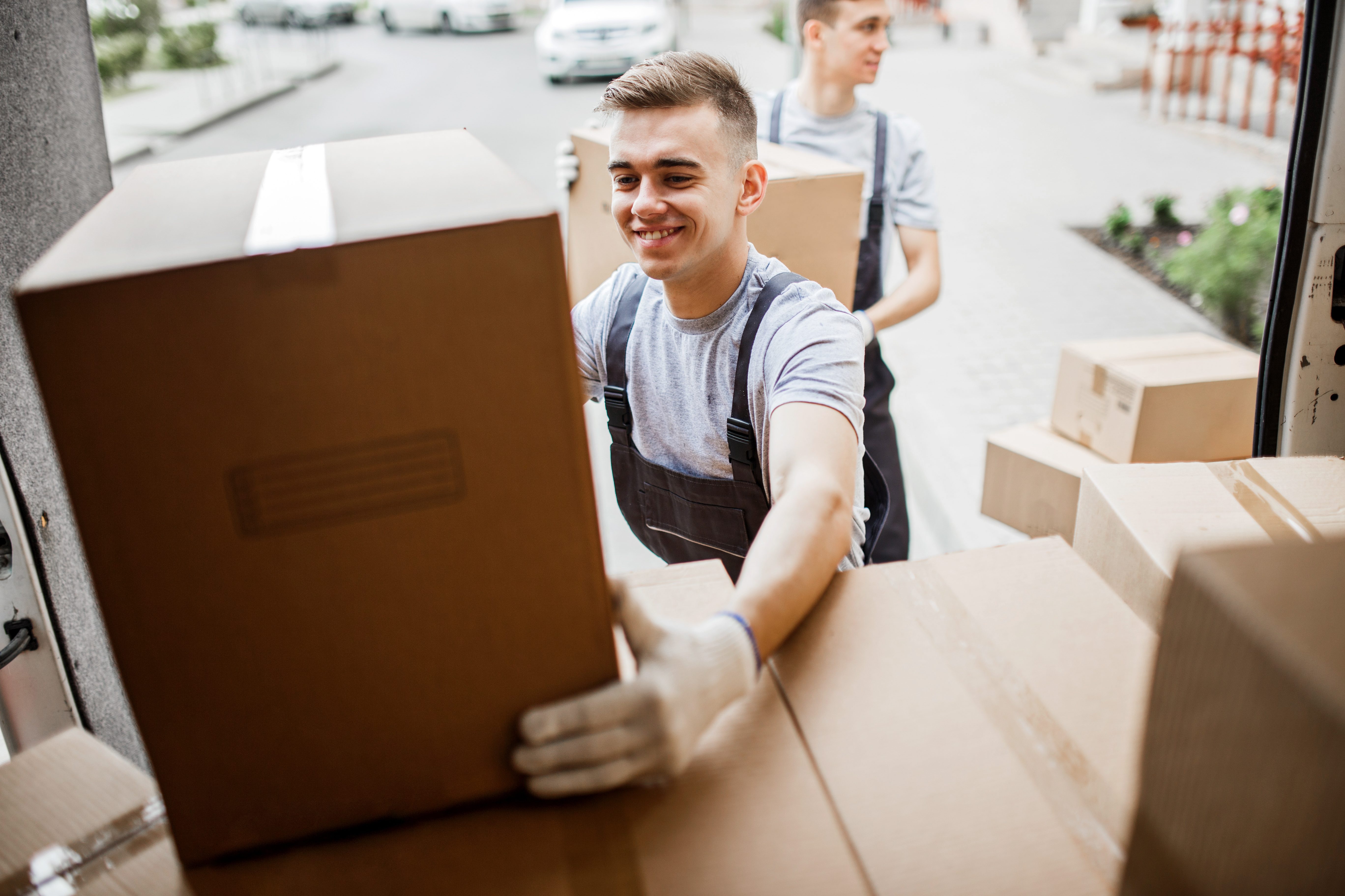 men stacking boxes into truck