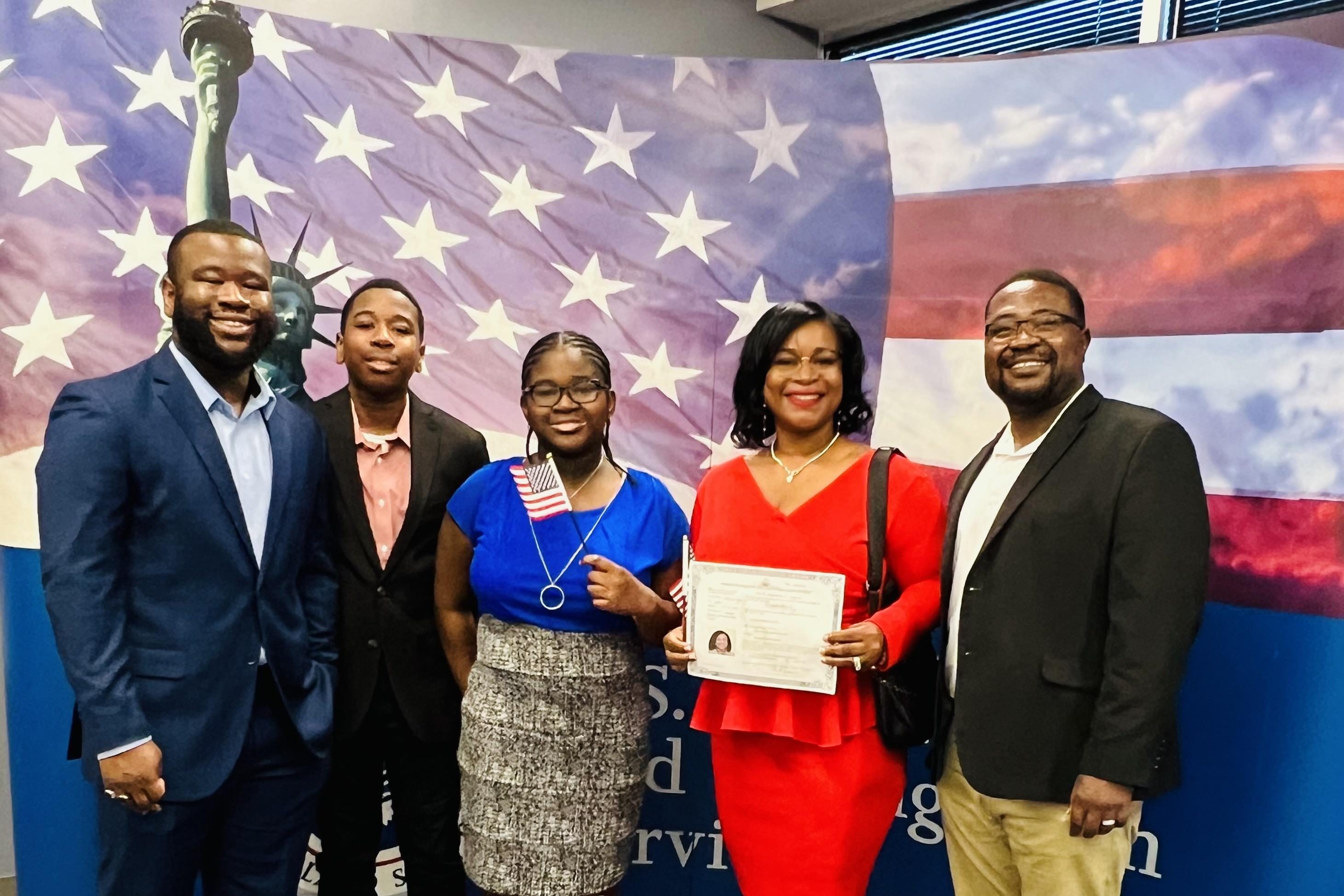 Dr. Bernice holding a certificate joined by four other people