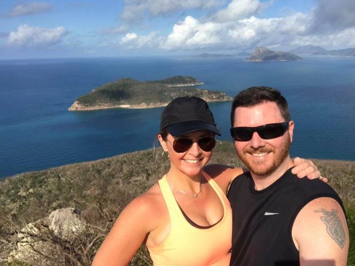 paul mcguire in sunglasses with a female wearing in a hat and sunglasses