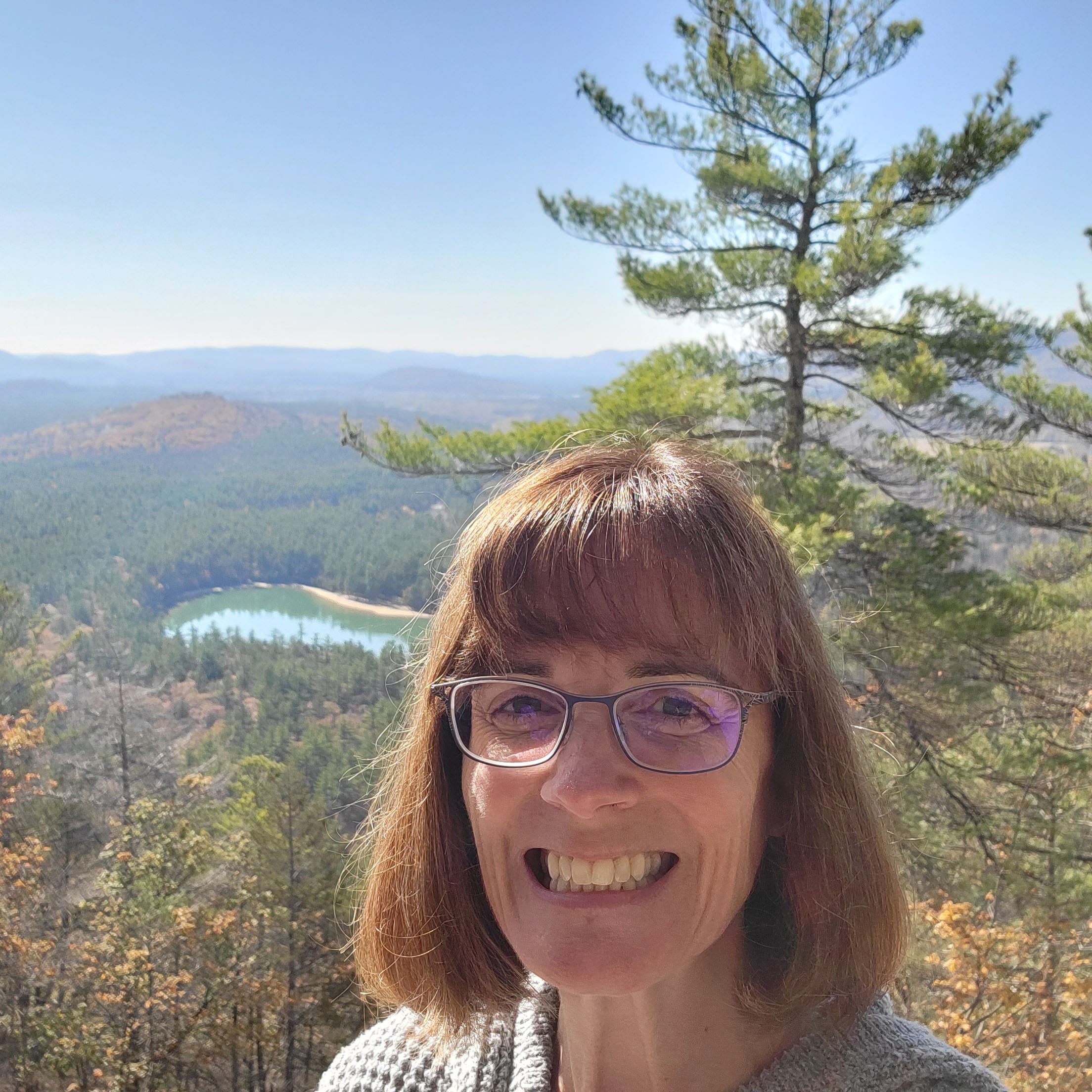 Teri Smith enjoying a sunny day at the top of a mountain