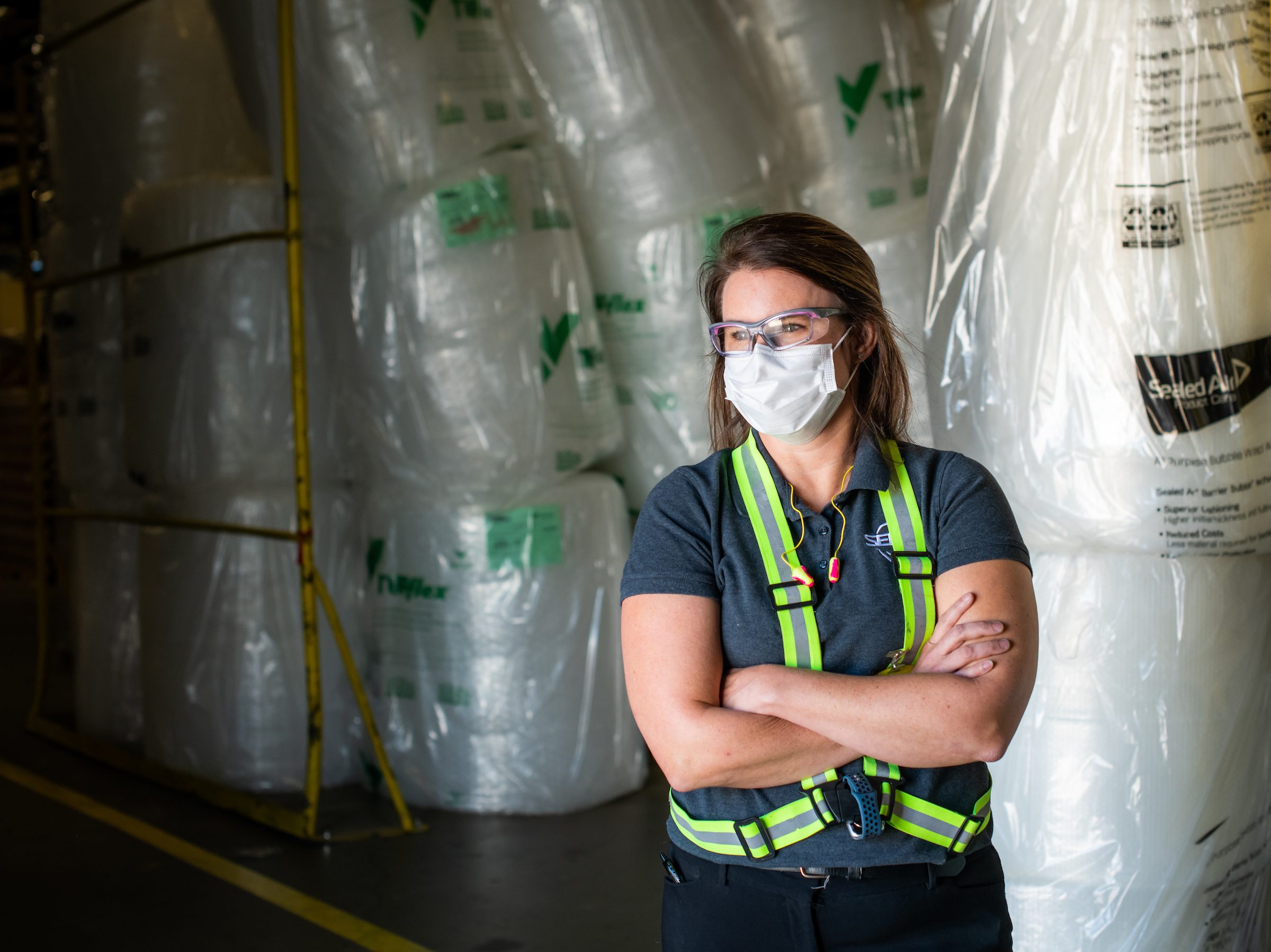 Karen Crisp in front of rolls of packaging