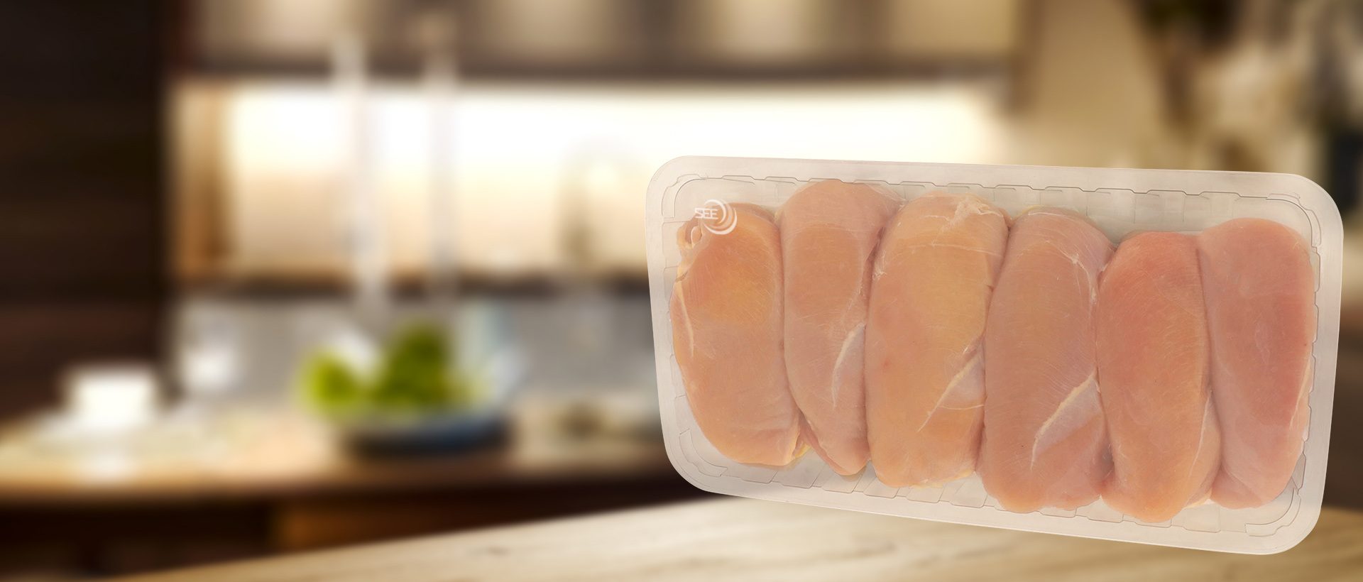 CRYOVAC brand SES overwrap film over pork in clear tray
