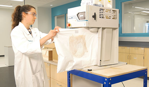 woman in packaging lab running tests on foam packaging solutions