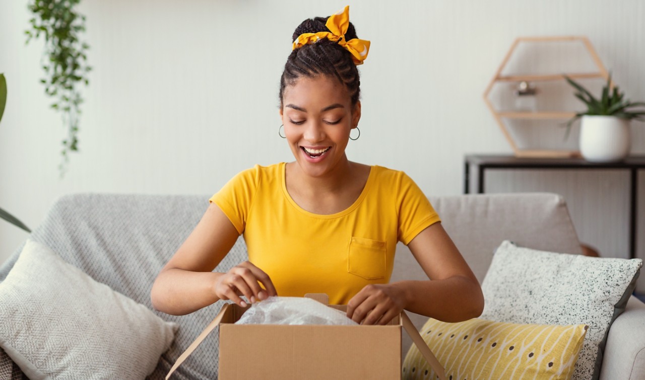 Woman excitedly opening box